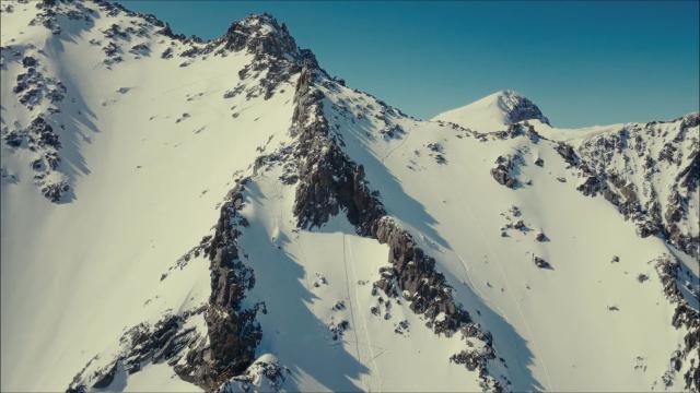 Snow covered mountain peaks and blue sky
