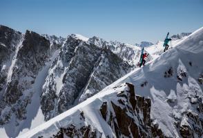 Two skiers climb into the Sierra Nevada backcountry for some ski touring. 