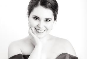 Black and white headshot of person in an off the shoulder dress