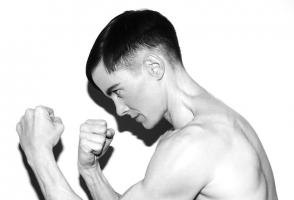Photo of program faculty, Cassils, in profile boxer pose