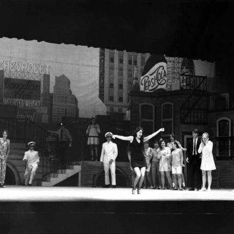 Archival photo of dancers performing on a set. 