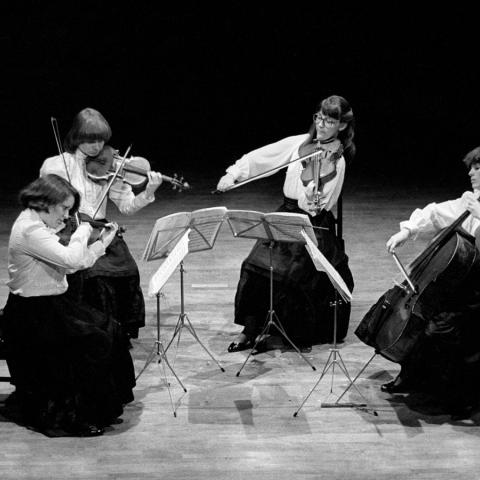 Archival photo of four women performing in a quartet. 