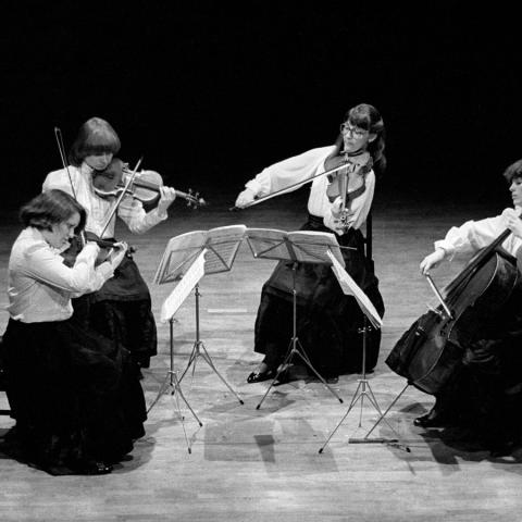 Archival photo of four women performing in a quartet. 