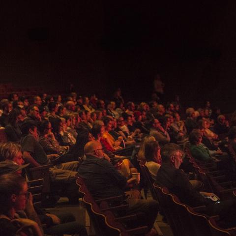 A packed audience views a performance in the Eric Harvie Theatre. 