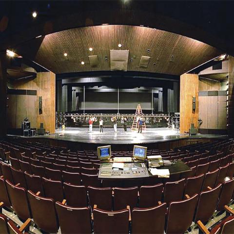 Artists rehearse in the empty theatre. 