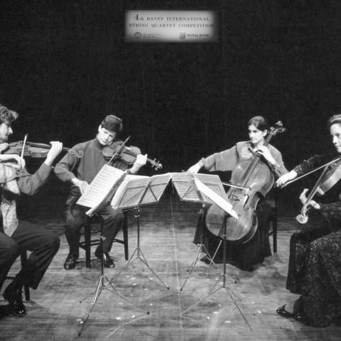 Archival photo of a mixed quartet performing on stage. 