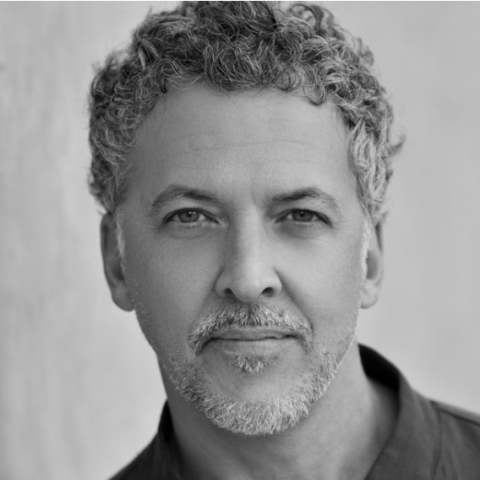 Men with curly short hair in a black shirt