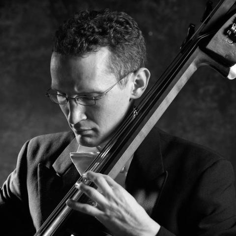Black and white photo of man playing double bass
