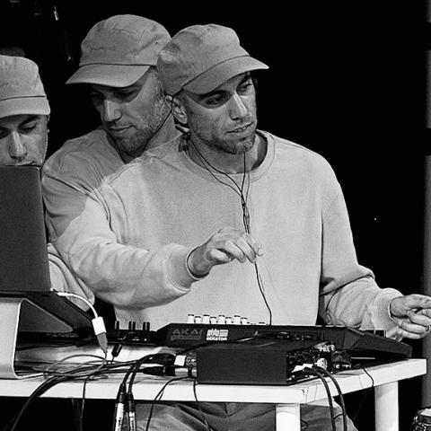 Men with a cap on, creating music