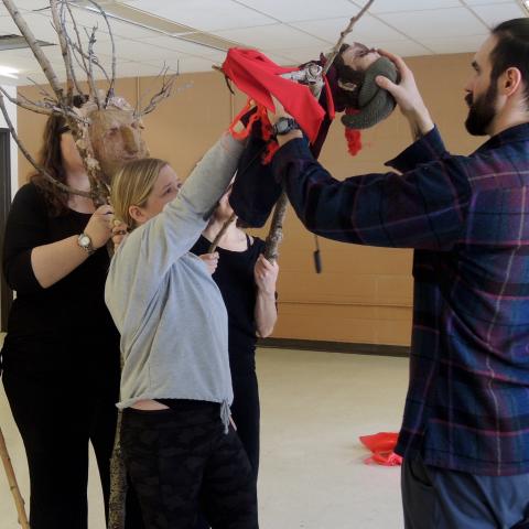 Participants rehearse with their tree and man puppets