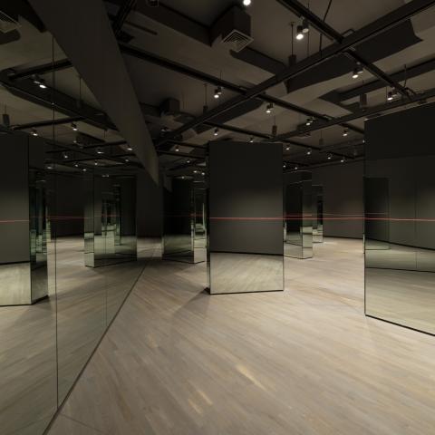 A wall of mirrors is on the left. On the right is a number of freestanding mirrors connected by a long red string.