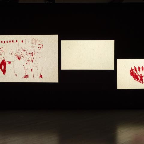 Three images are projected onto a wall. Each image features a red and white animation.