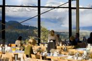 The Vista's dining room with patrons, showing glass windows surrounding the entire space with perfect views of the bow v