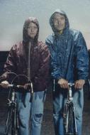 Members of the band Ghostkeeper standing with bikes in the rain.