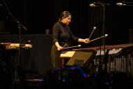 woman playing instruments on a stage