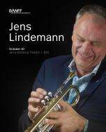 Jens Lindemann portrait laughing and holding brass in his hands 