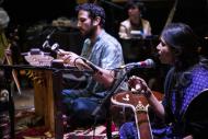 Two musicians playing instruments and singing