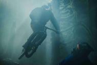 Mountain biker jumping in a dense forest